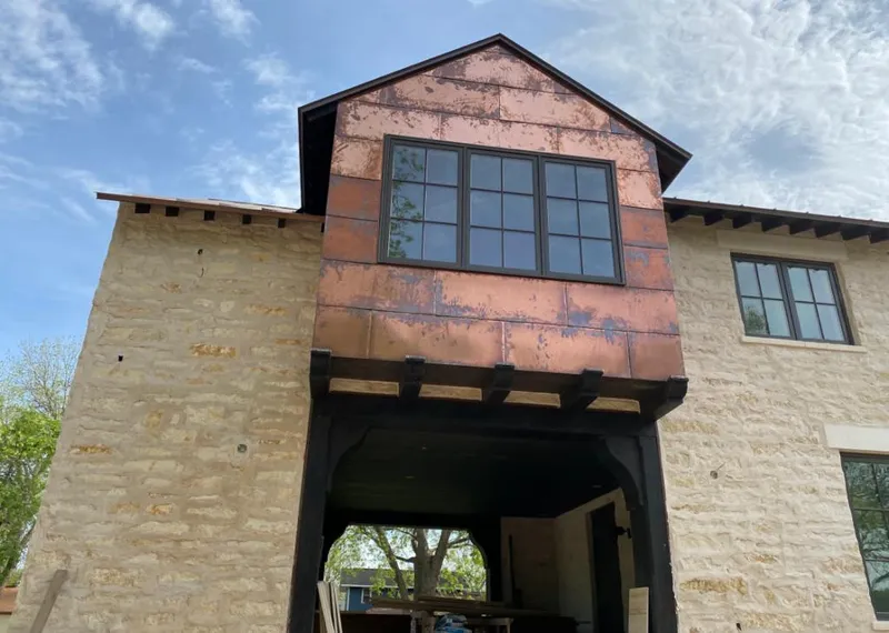 Copper metal panel facade on a stone building for Skylight Installation in Mechanicsville